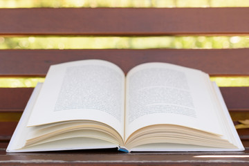 Open book lying on bench, close up