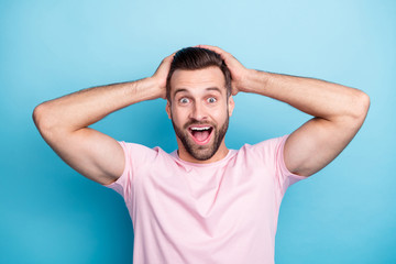 Closeup photo of amazing guy with open mouth holding arms on head not believe eyes astonished...