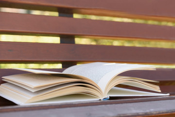 Open book lying on bench, close up