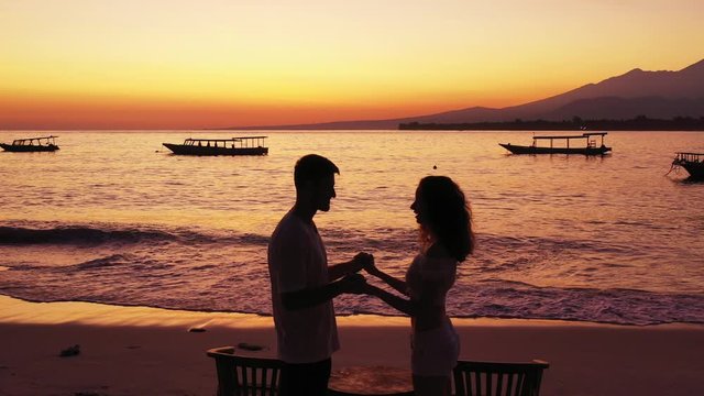 proposal during the sunset on the sandy beach. Bali indonesia, young couple flirting on the playa