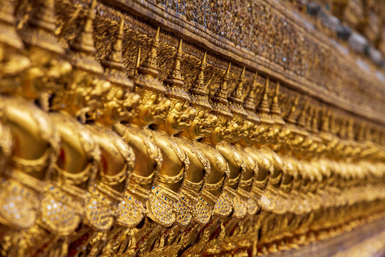 Intricate Golden Arcgitectural Details of a Traditional Thai Buddhist Temple