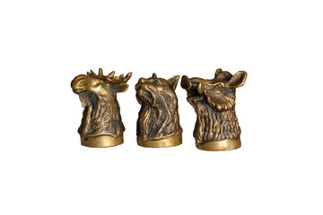Bronze figures of animal heads isolated on white background. Moose. Cat. Pig. Selective focus.