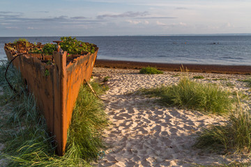 An old rusty and damaged  batteship wreck on the  beach. Hel,  Poland