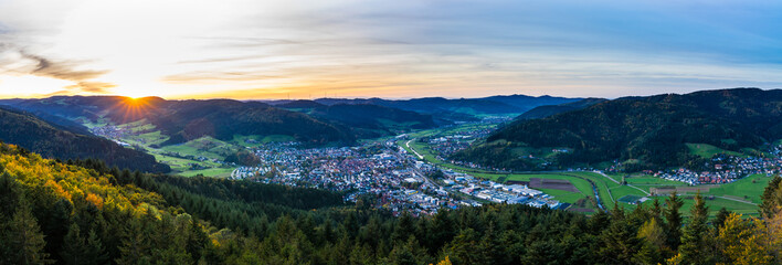 Germany, XXL aerial panorama view above black forest village haslach im kinzigtal and endless nature landscape over tree tops at sunset in autumn season - obrazy, fototapety, plakaty