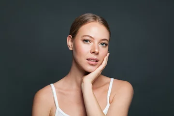 Perfect girl on gray background. Happy young woman portrait