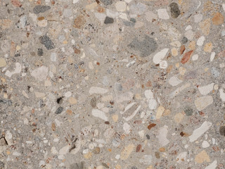 Grinded concrete texture with exposed gravel stones © Philipp Berezhnoy