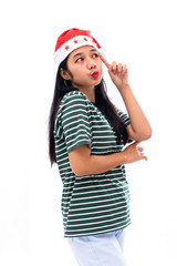 portrait of young asian woman wearing a santa hat and wearing casual clothes lifting a finger near the head looks thinking