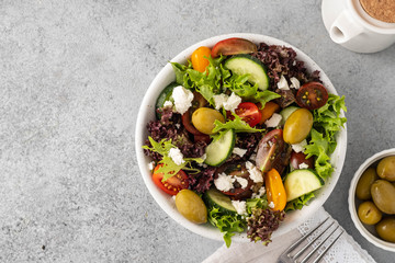 Salad of fresh vegetables and herbs with olives and feta cheese.
