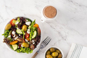 Salad of fresh vegetables and herbs with olives and feta cheese.