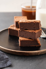 Double Chocolate Brownies. Homemade chocolate fudge brownies with chocolate chips and black background. Copy space.