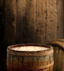 Fototapeta premium Wooden barrel on a table and textured background