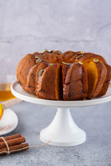 Pumpkin cake with honey on a gray background. Copy space.