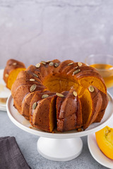 Pumpkin cake with honey on a gray background. Copy space.