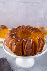 Pumpkin cake with honey on a gray background. Copy space.
