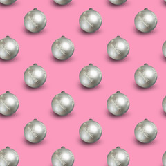 Seamless Christmas pattern with shiny silver balls on pink background.