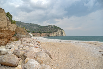 Rocks in the Beach of Mattinata with Cloudy Sky