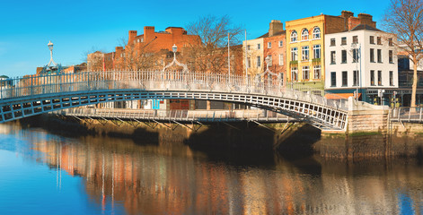 Dublin, panoramic image of Half penny bridge, or Ha'penny bridge, on a bright day with beautiful...