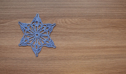 Fototapeta na wymiar Six-pointed star embroidered from threads.