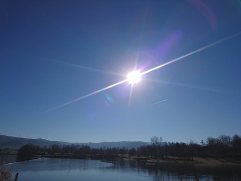 beautiful breitenauer see with mountain, blue sky and sun