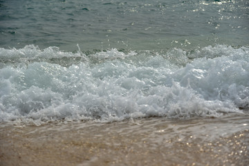 Foam of the Sea Waves on the Pebble Beach