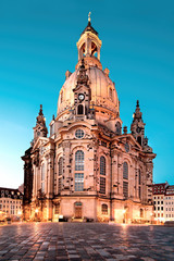 Illuminated Church of Our Lady, or Frauenkirche, at night in Dresden, Germany, on a quiet evening with blue sky. Famous travel landmark and symbol of Peace in Saxony, Germany.