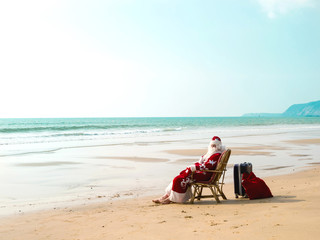 Santa travel with a suitcase at sea