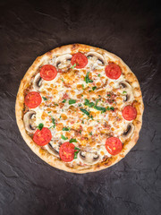 Pizza with mushrooms, tomatoes, sausage and cheese