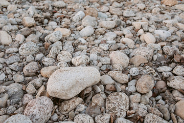 Pebbles stone texture and background. Abstract background made with small gray stones.