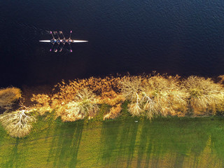 Boat four rowing, Aerial drone top view, Corrib river, Galway city, Ireland. Concept outdoor activity, sport, adventure, © mark_gusev