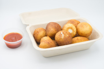 Fried Risotto Arancini stuffed with cheese, served with tomato sauce