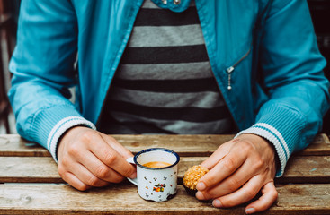 Midsection of women having an espresso and a praline