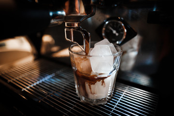 Close up of coffee machine making iced coffee