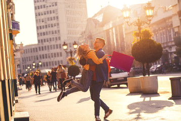 Beautiful young couple walking in and city enjoying in shopping together.