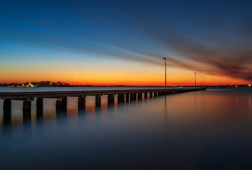 Naklejka na ściany i meble Smoky sunset at Como Jetty, Perth Australia. Hot Summer Night. Reflections. 