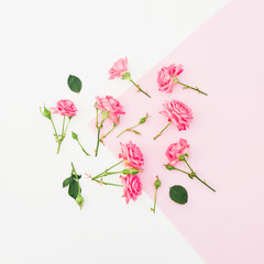Pink and white background with pink roses flowers. Flat lay.