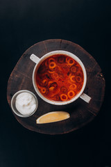 soup pickle with lemon lies on a wooden substrate on the table