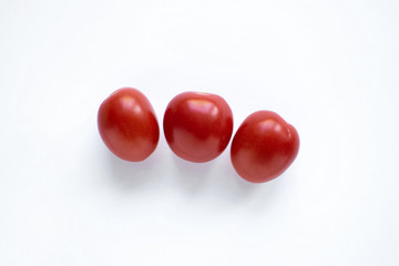 three small tomatoes isolated on white background