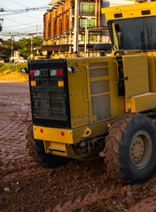 Grader is working on road construction. Grader industrial machine on construction of new roads. Heavy duty machinery working on highway. Construction equipment. Compaction of the road.