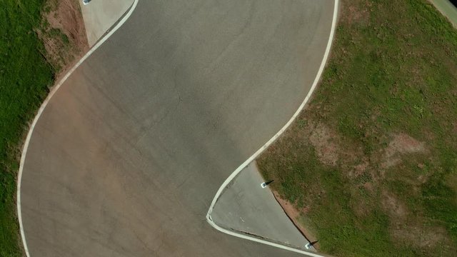 Top down ascending aerial shot, showing a shicane on a racetrack.