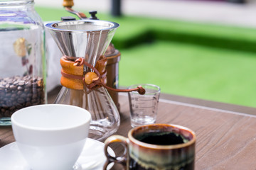 Coffee drip equipment set on wooden table.