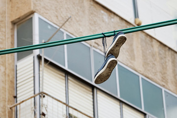 Shoes hang on an electric wire on the Haifa street in Israel