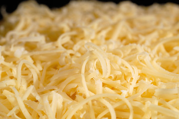 Salad seasoned with mayonnaise and sprinkled with grated cheese. Shallow depth of field