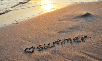 The word Summer written on sand.
