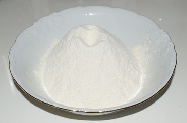 bowl of flour on a white background