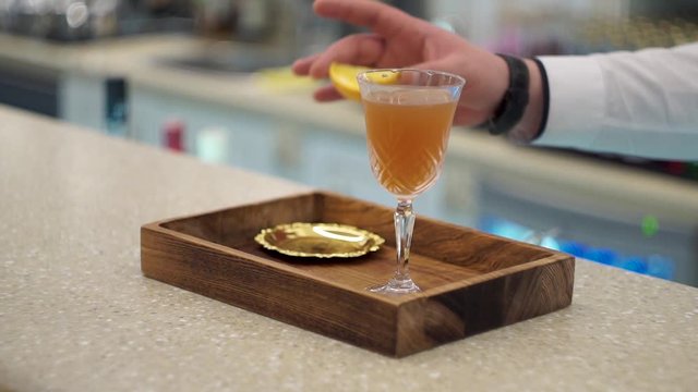 Bartender serves blood and sand cocktail