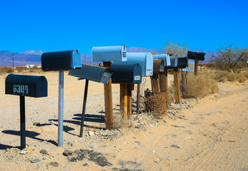 Grunge mail boxes in a row at California Mohave desert