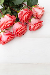 Pink roses on white wooden background. Floral frame, Mothers day, st. Valentines day roses, Bouquet of pink roses, Floral background image with copy space for text