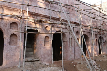 Reconstruction of an ancient fortress in Haryana, India. Installed scaffolding from bamboo sticks.