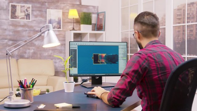 Over the shoulder shot of young game developer working from home