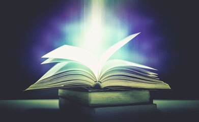 Imagine a picture book of an ancient book opened on a wooden table with a sparkling golden background. With magical power, magic, lightning around a glowing glowing book In the room of darkness